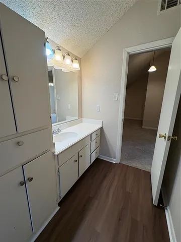 a bathroom with a double vanity sink and mirror