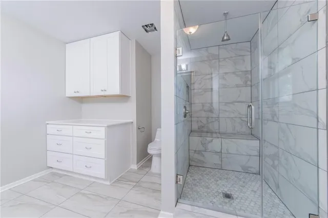 a bathroom with a shower a sink and a mirror