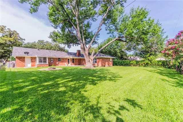 a front view of a house with yard and green space