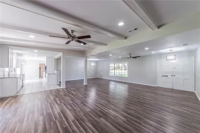 a view of an empty room and wooden floor