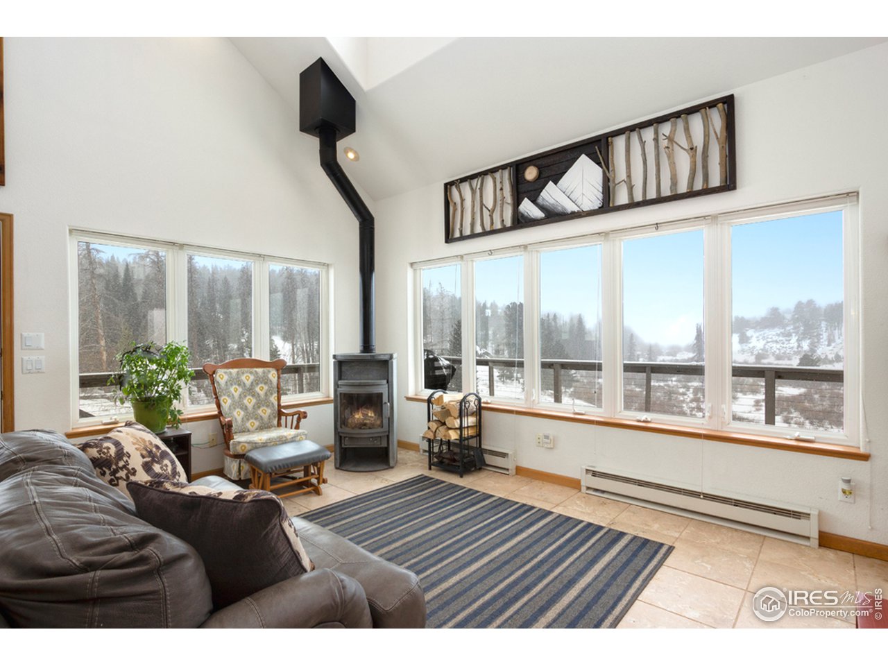 759 Huron Road Red Feather Lakes, CO 80545 - Photo 4 of 21 great room with soapstone fireplace