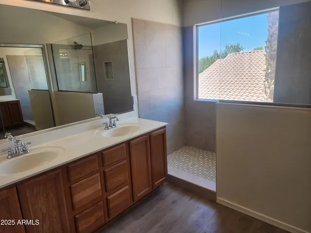 a bathroom with a double vanity sink and mirror