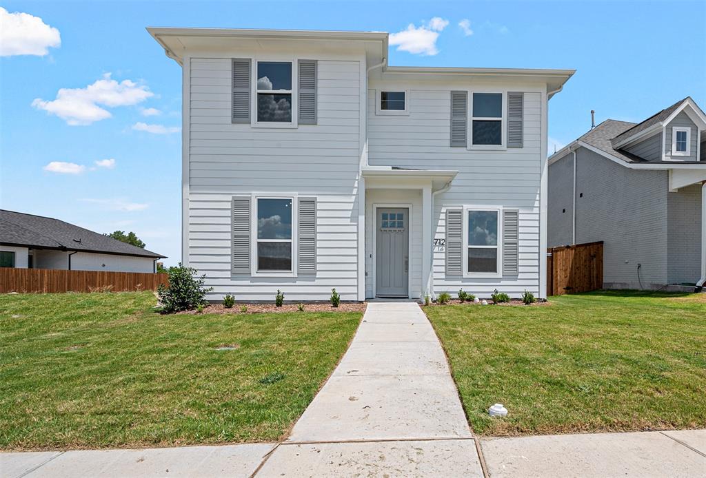 a front view of a house with yard