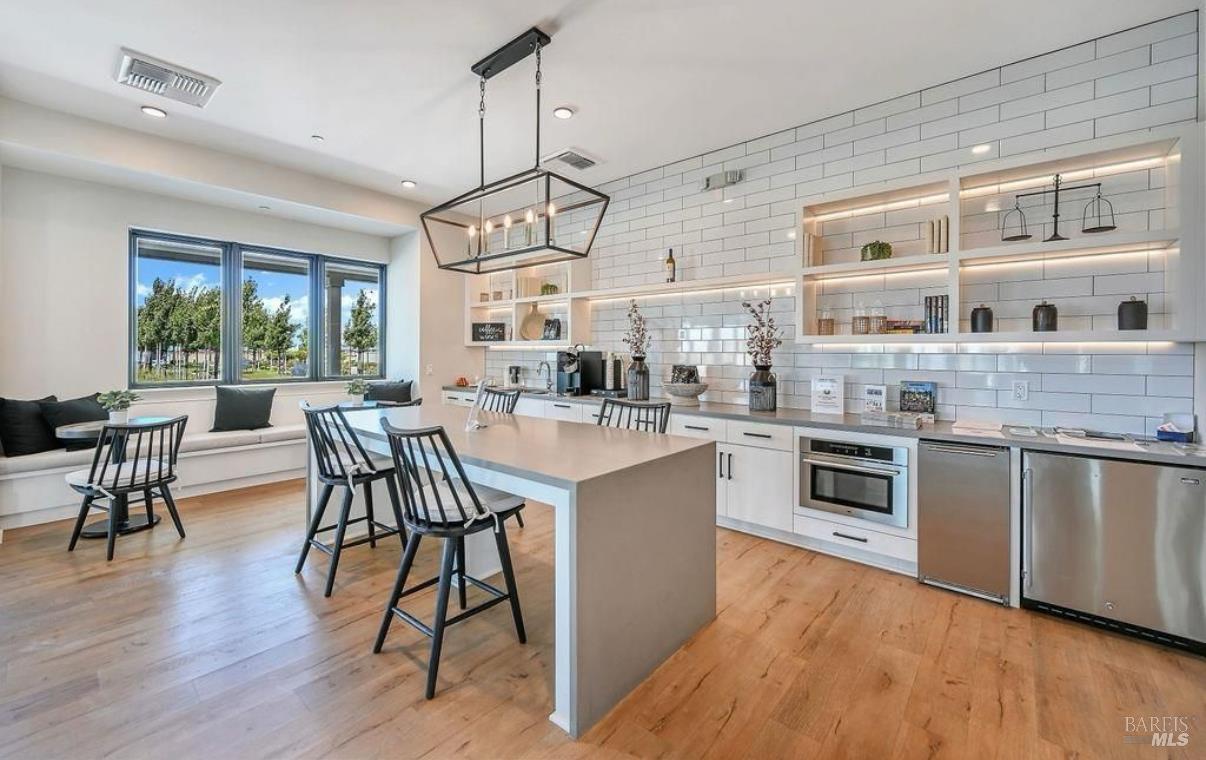 2283 Revival Lane Rio Vista, CA 94571 - Photo 38 of 44 a open kitchen with stainless steel appliances granite countertop a stove a sink dishwasher a microwave oven a dining table and chairs with wooden floor