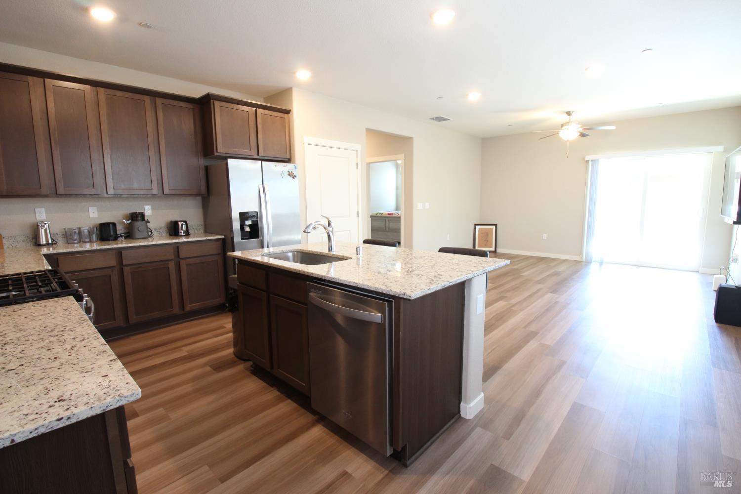 2283 Revival Lane Rio Vista, CA 94571 - Photo 7 of 44 a kitchen with kitchen island granite countertop a sink cabinets and wooden floor