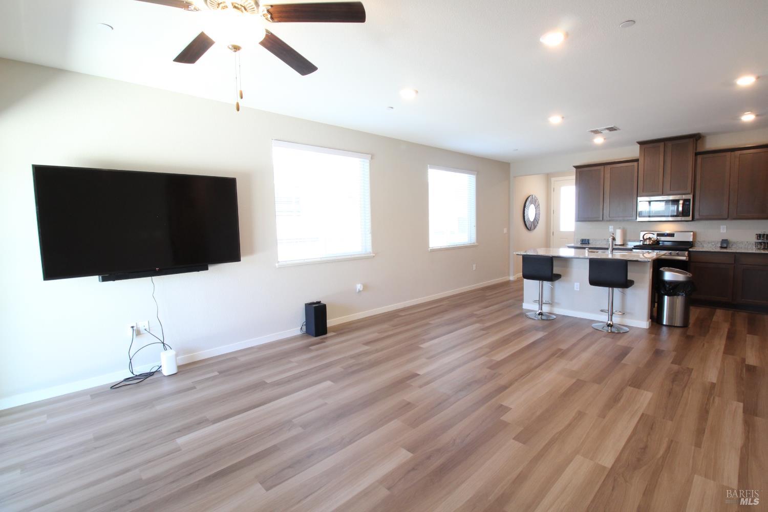 2283 Revival Lane Rio Vista, CA 94571 - Photo 9 of 44 a living room with stainless steel appliances kitchen island granite countertop furniture and a flat screen tv