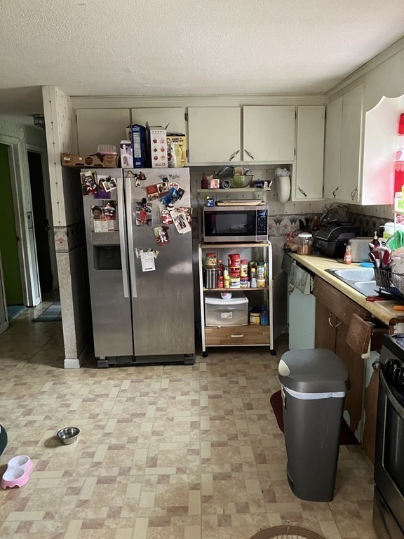 80 Keddy Street Springfield, MA 01109 - Photo 3 of 11 a kitchen with a refrigerator and a stove