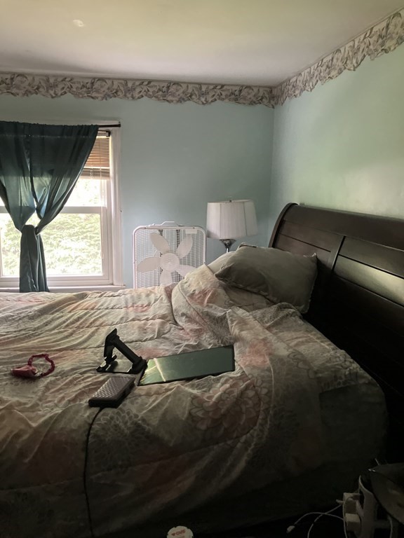80 Keddy Street Springfield, MA 01109 - Photo 8 of 11 a bed sitting in a bedroom next to a window