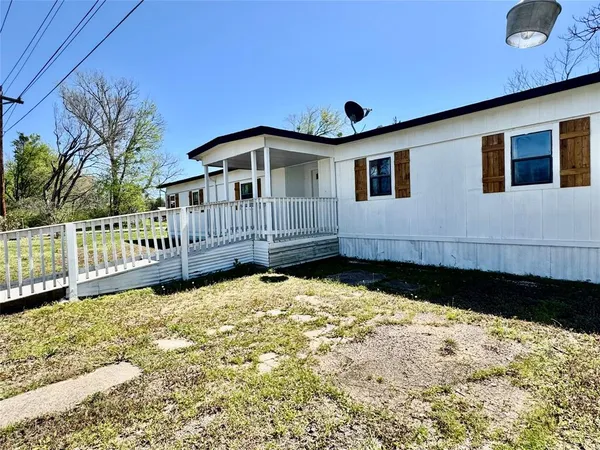 a front view of a house with wooden fence