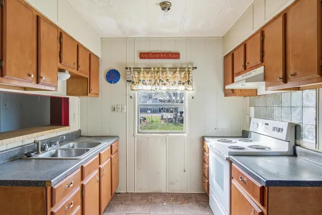 an empty room with windows and cabinet