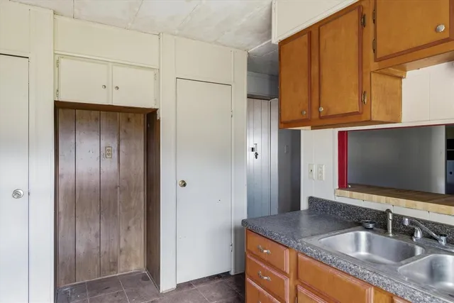 a view of a big room with chandelier fan