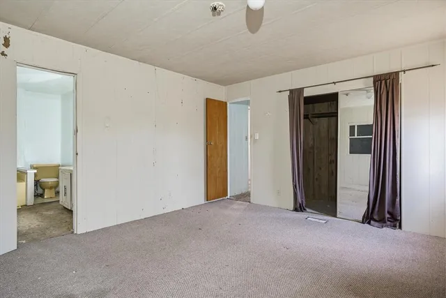 a front view of a house with a garden and deck