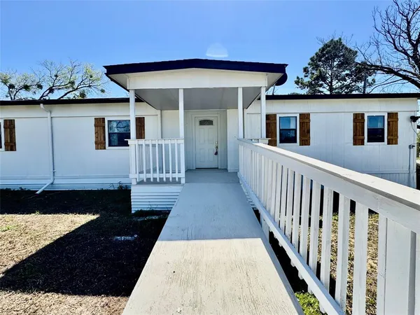 a view of a house with wooden deck
