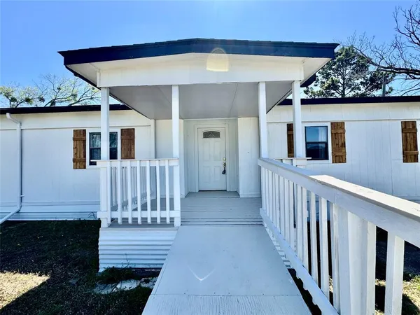 a view of a house with wooden floor and a yard