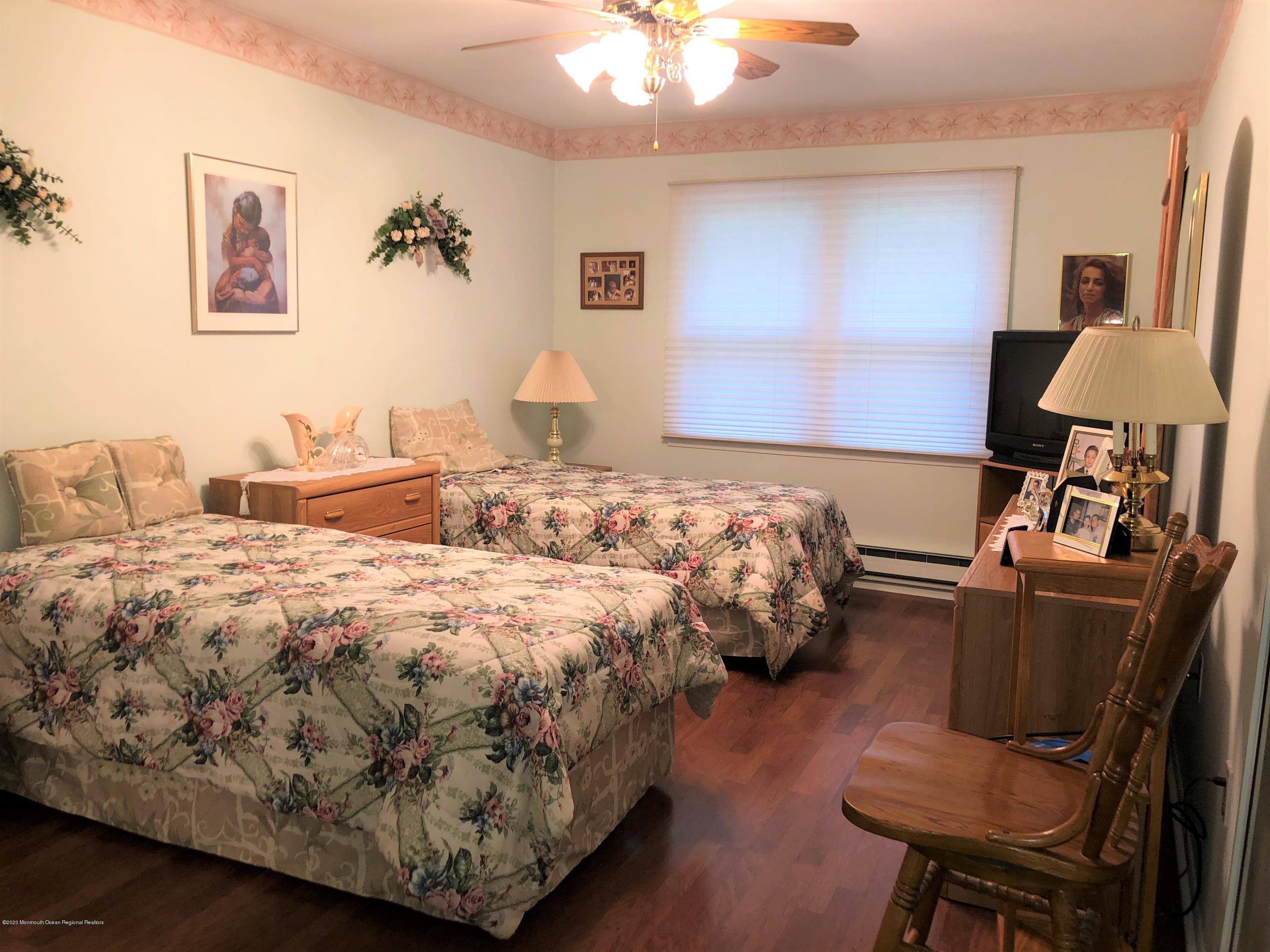 22 Abbey Road Brick, NJ 08723 - Photo 12 of 22 a bedroom with bed and a chandelier