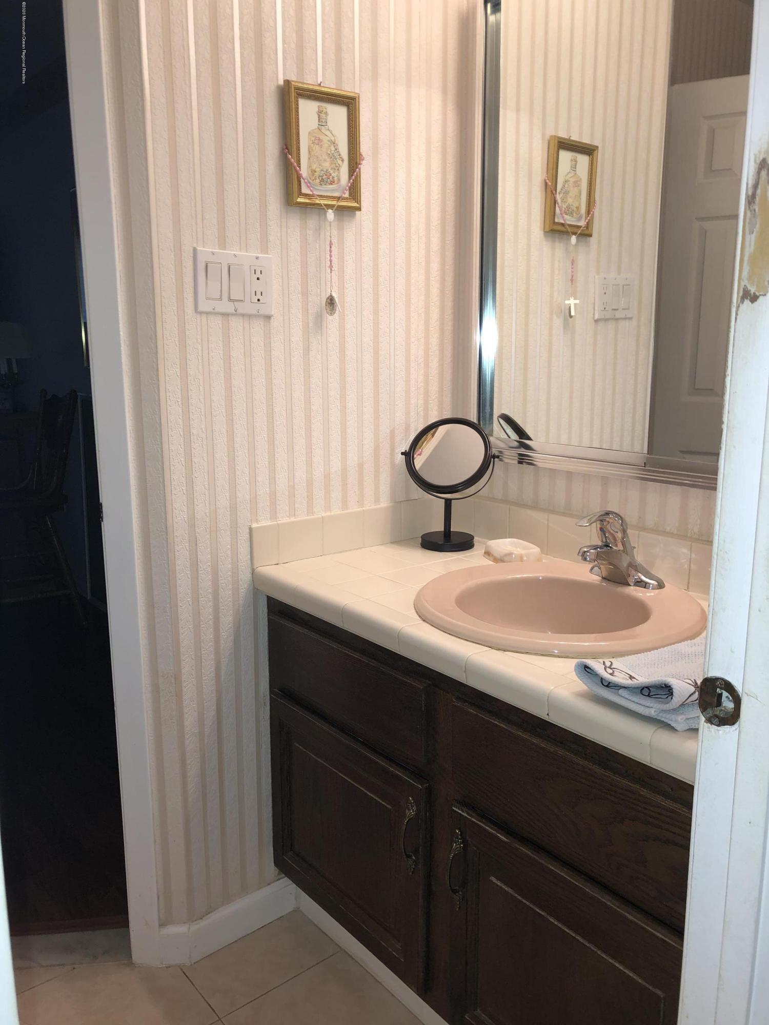 22 Abbey Road Brick, NJ 08723 - Photo 13 of 22 a bathroom with a sink and a mirror