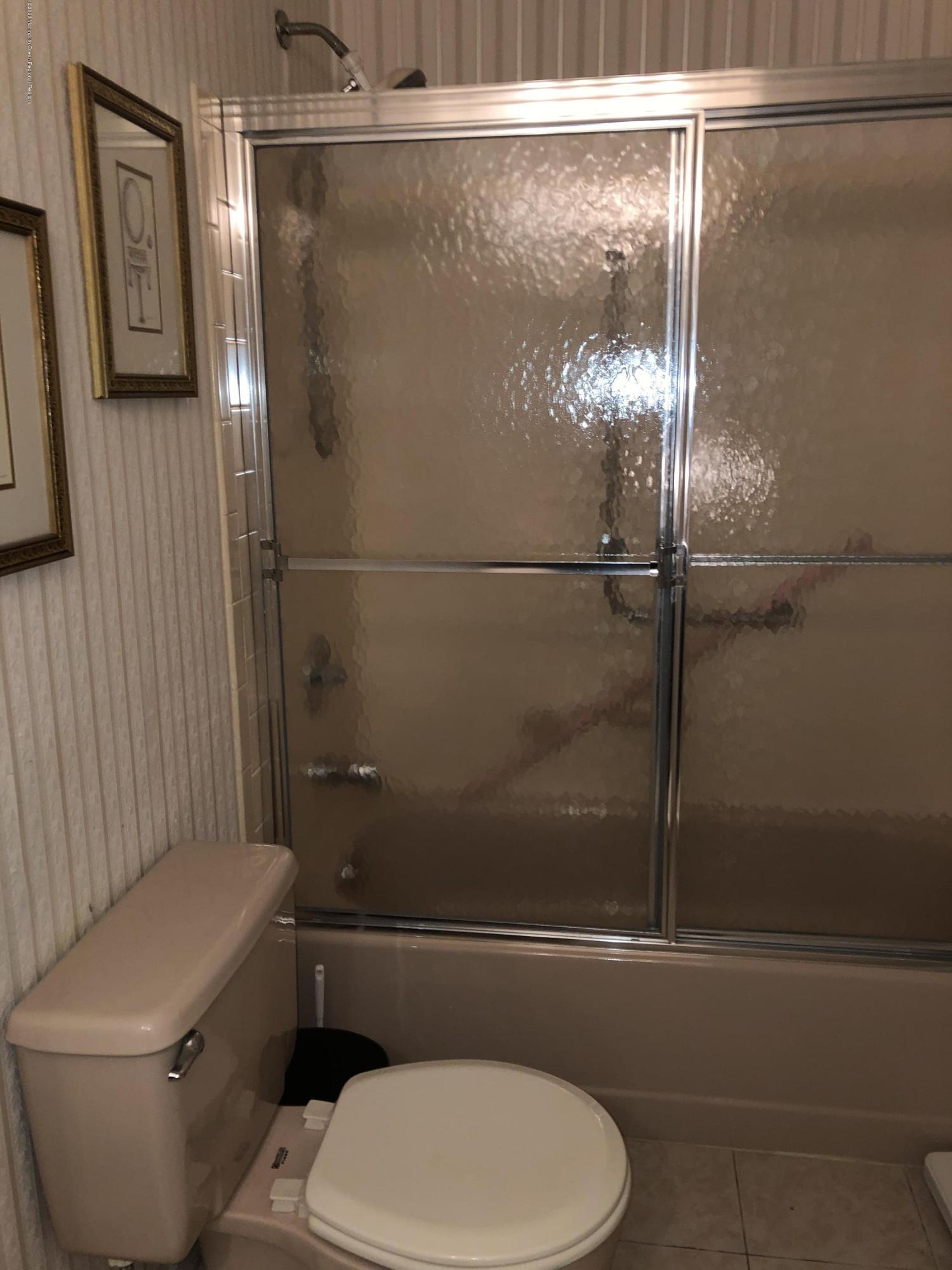 22 Abbey Road Brick, NJ 08723 - Photo 14 of 22 a white toilet sitting next to a bath tub