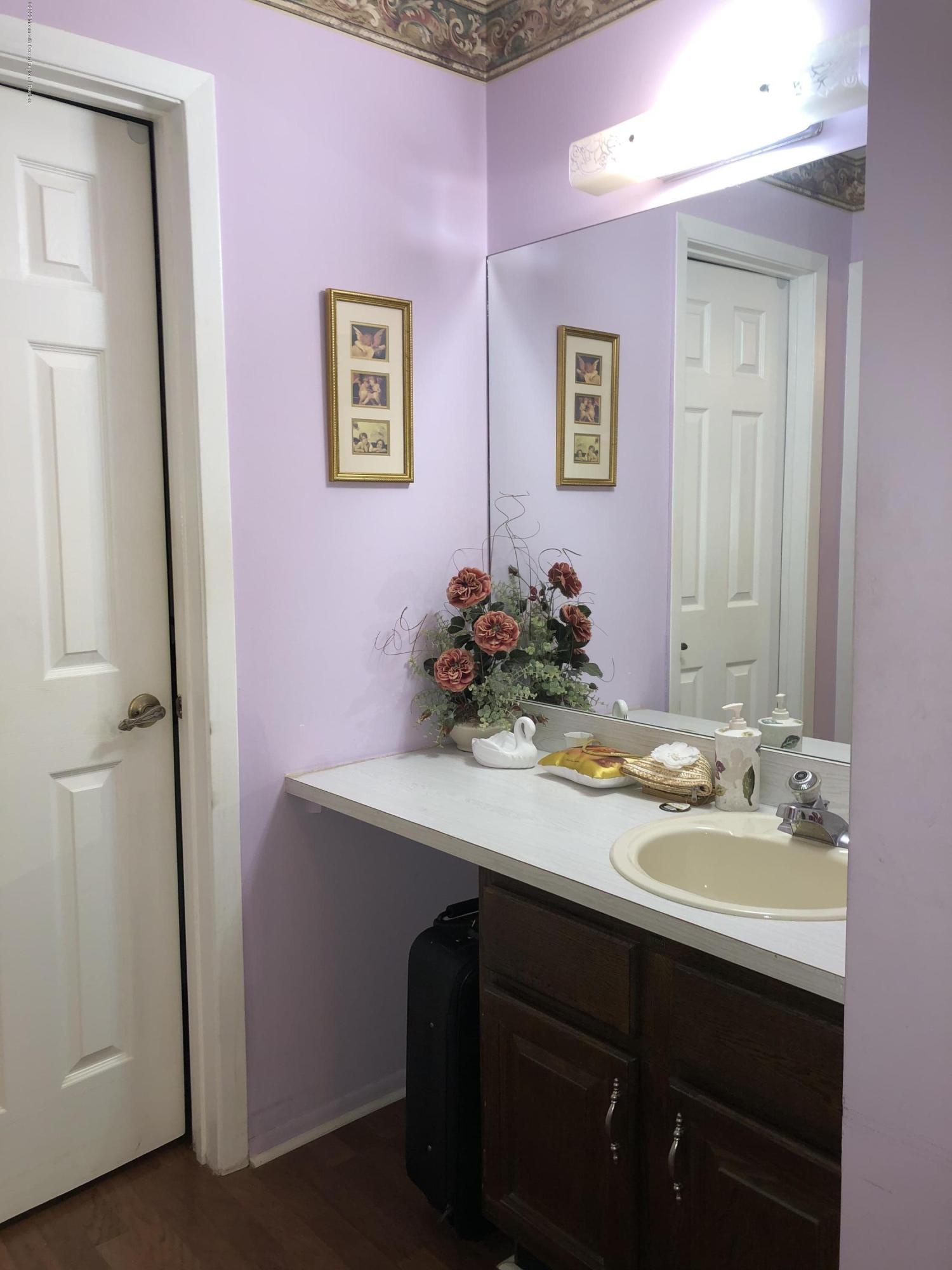 22 Abbey Road Brick, NJ 08723 - Photo 17 of 22 a bathroom with a sink mirror and vanity