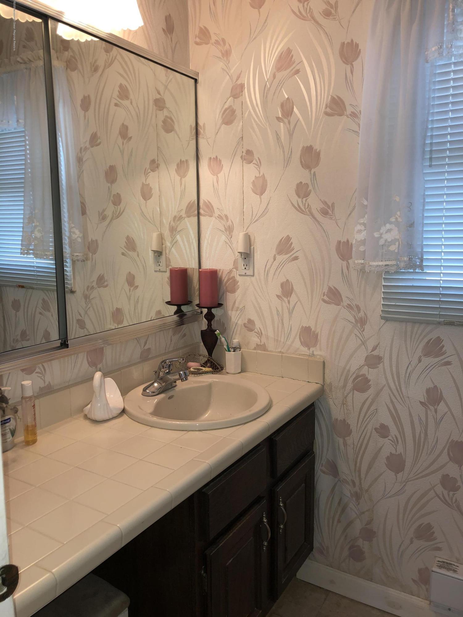 22 Abbey Road Brick, NJ 08723 - Photo 18 of 22 a bathroom with a sink and a mirror