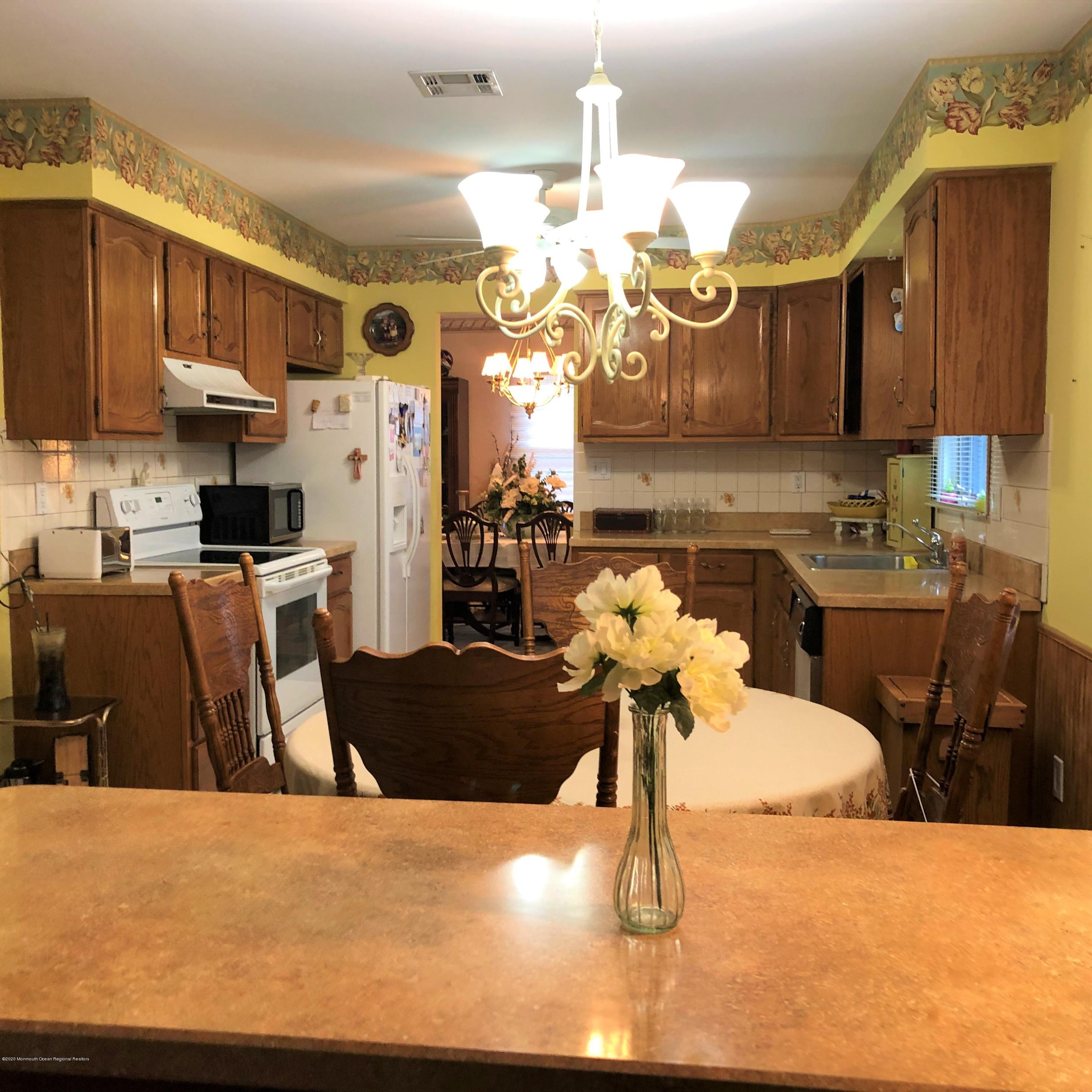 22 Abbey Road Brick, NJ 08723 - Photo 6 of 22 a kitchen with cabinets and wooden floor