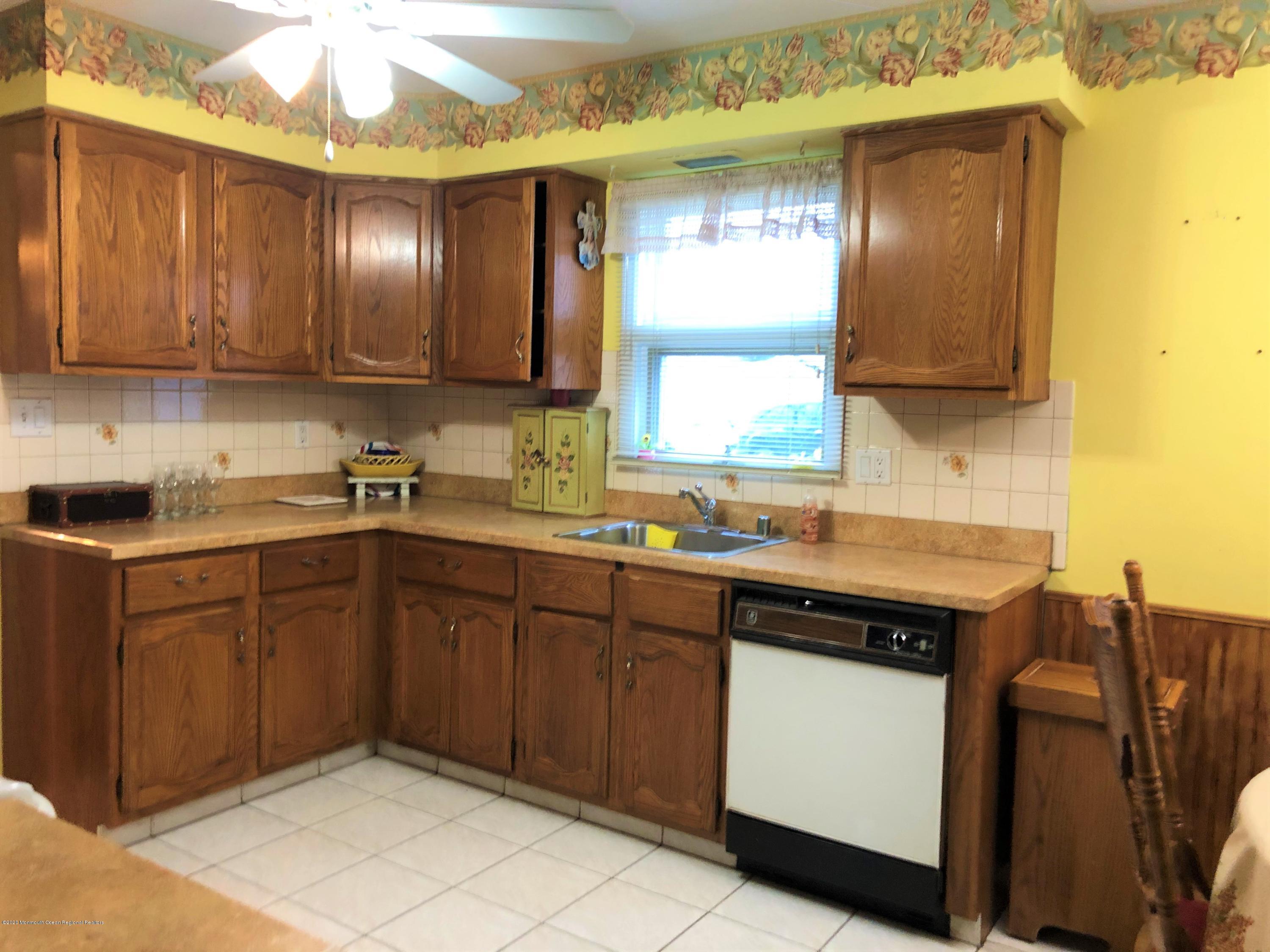 22 Abbey Road Brick, NJ 08723 - Photo 7 of 22 a kitchen with stainless steel appliances granite countertop wooden cabinets a sink and dishwasher
