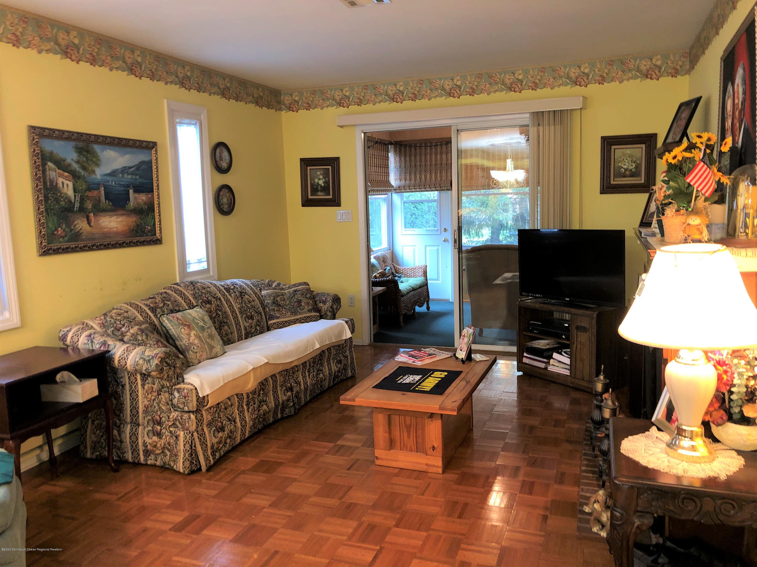 22 Abbey Road Brick, NJ 08723 - Photo 9 of 22 a living room with furniture a rug and a lamp