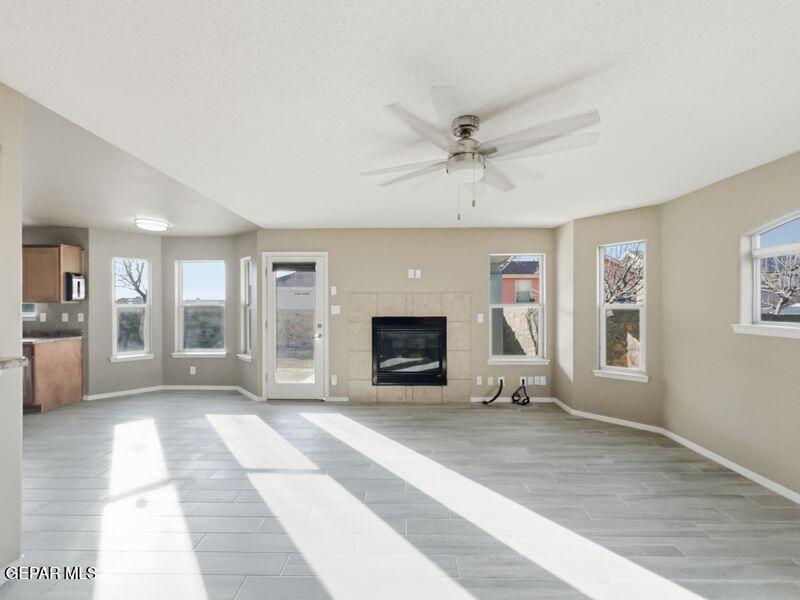533 Flanagan Place El Paso, TX 79928 - Photo 11 of 52 a view of a livingroom with a fireplace a ceiling fan and windows