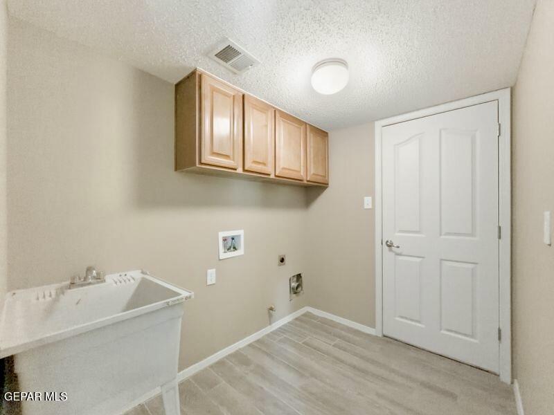 533 Flanagan Place El Paso, TX 79928 - Photo 47 of 52 a bathroom with a sink and cabinets
