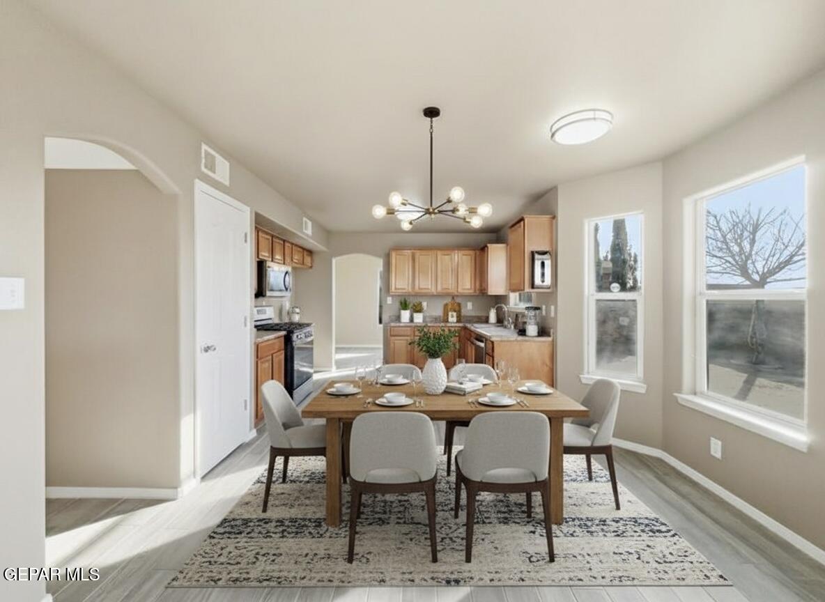 533 Flanagan Place El Paso, TX 79928 - Photo 8 of 52 a view of a dining room with furniture and a chandelier