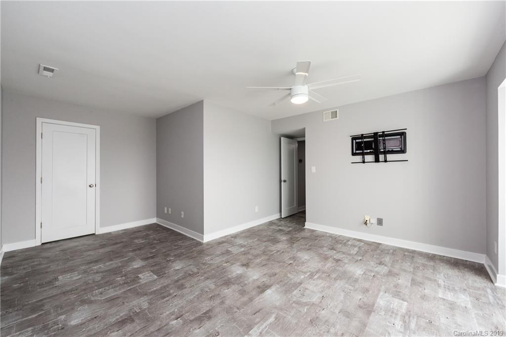 11077 Running Ridge Road Charlotte, NC 28226 - Photo 15 of 21 an empty room with a ceiling fan and window