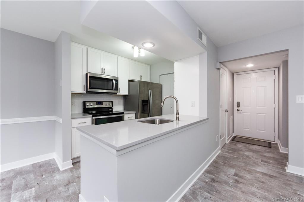 11077 Running Ridge Road Charlotte, NC 28226 - Photo 6 of 21 a kitchen with a sink a stove a microwave and refrigerator