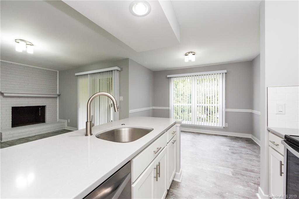 11077 Running Ridge Road Charlotte, NC 28226 - Photo 10 of 21 a kitchen with a sink a counter top space and a stove top oven