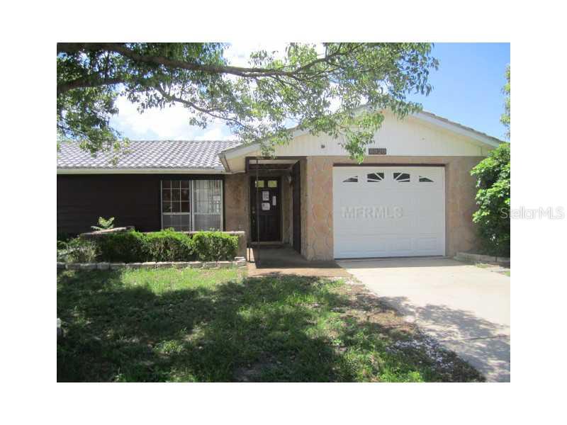 6920 Tierra Verde Street Port Richey, FL 34668 - Photo 1 of 1 a view of a house with a yard