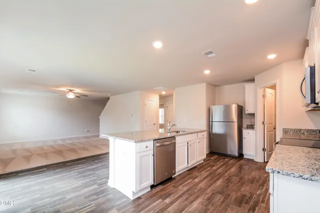 a kitchen with a sink stainless steel appliances and cabinets
