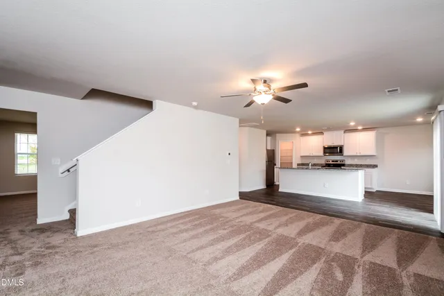 a view of a kitchen with a sink and a refrigerator