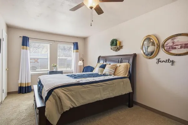 a bed sitting in a bedroom next to a window