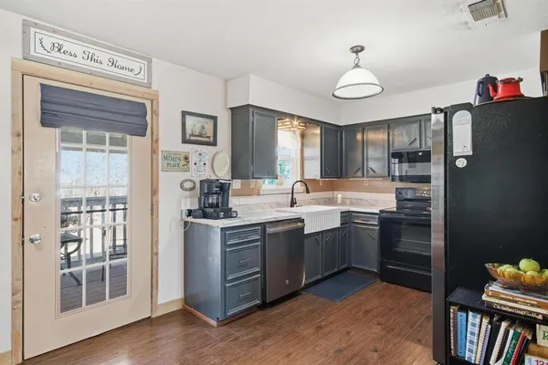 a kitchen with stainless steel appliances granite countertop a refrigerator and a sink