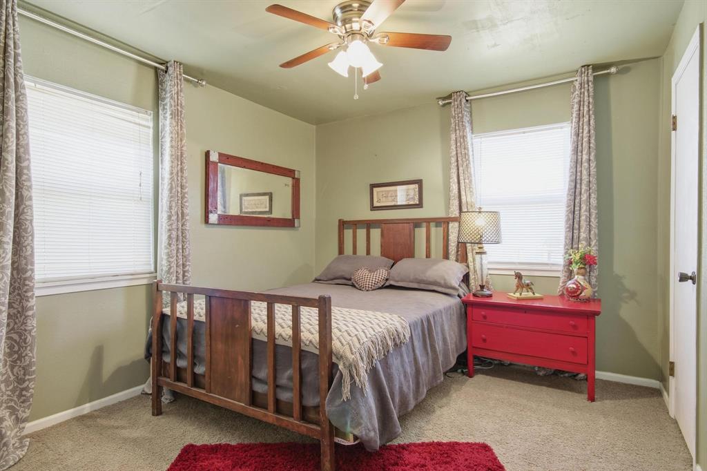 126 4th Street Tuscola, TX 79562 - Photo 20 of 31 a bedroom with a bed and a chandelier