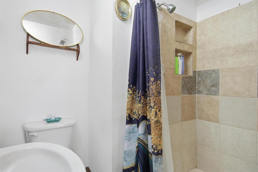 126 4th Street Tuscola, TX 79562 - Photo 21 of 31 a bathroom with a toilet and a shower