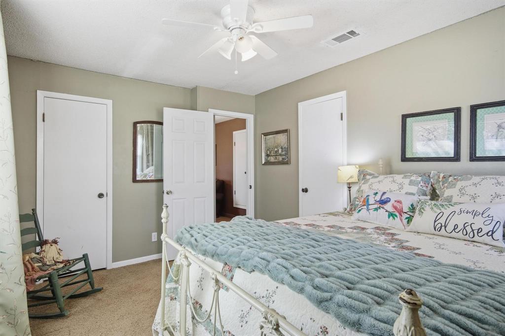 126 4th Street Tuscola, TX 79562 - Photo 25 of 31 a bedroom with a large bed and a chandelier