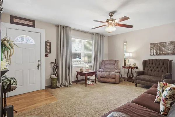 a living room with furniture and a chandelier