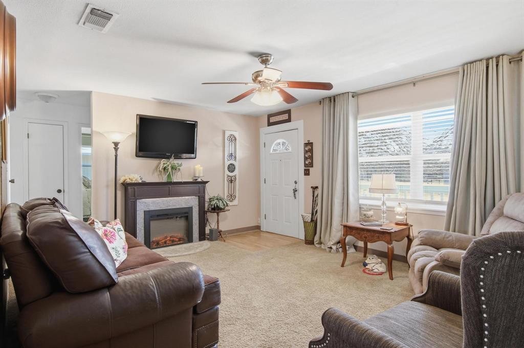 126 4th Street Tuscola, TX 79562 - Photo 8 of 31 a living room with furniture a flat screen tv and a fireplace