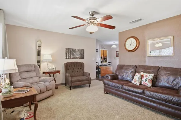 a living room with furniture and a clock