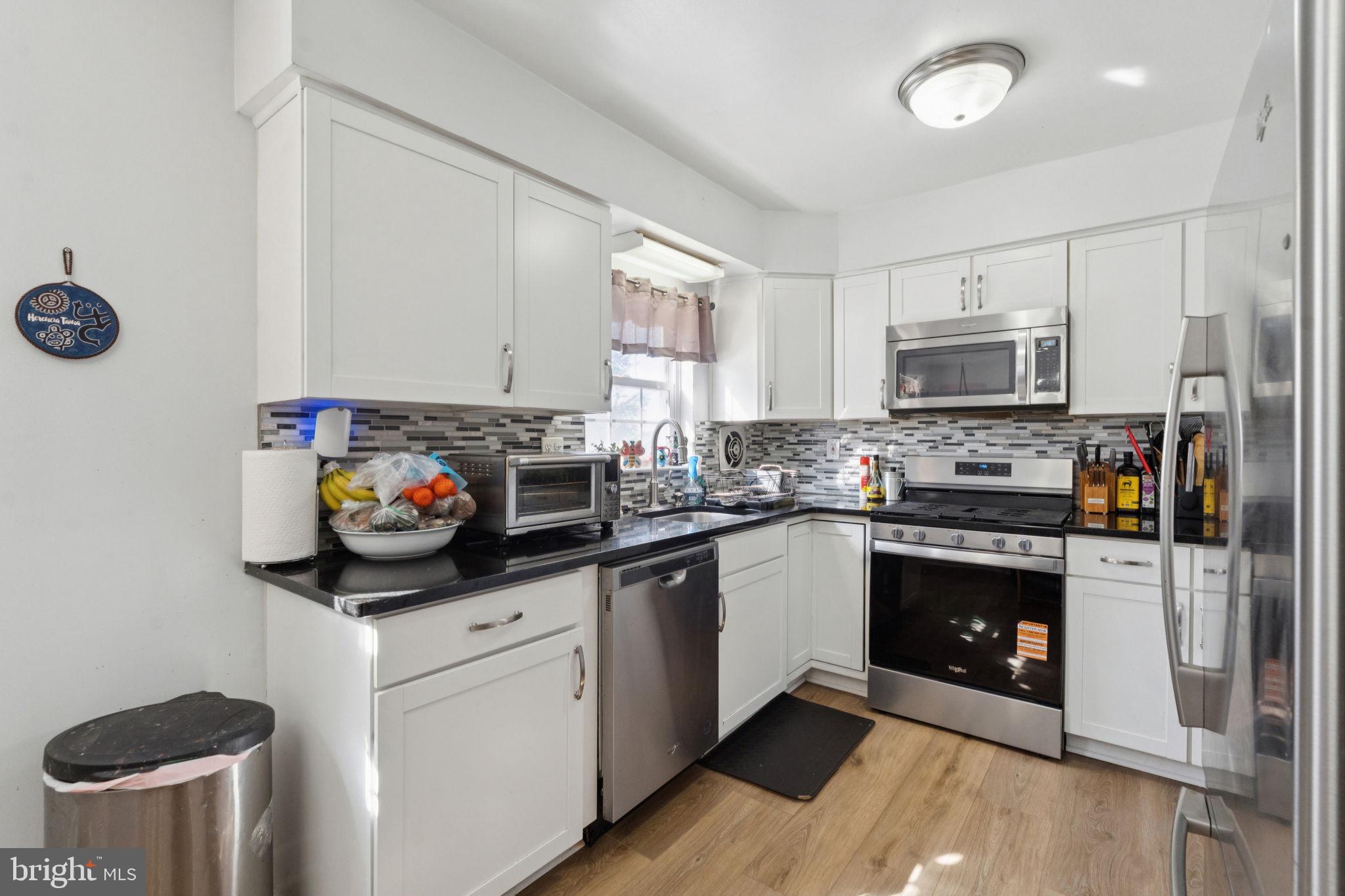 3978 Stevenson Street Philadelphia, PA 19114 - Photo 11 of 25 a kitchen with a sink a stove and cabinets
