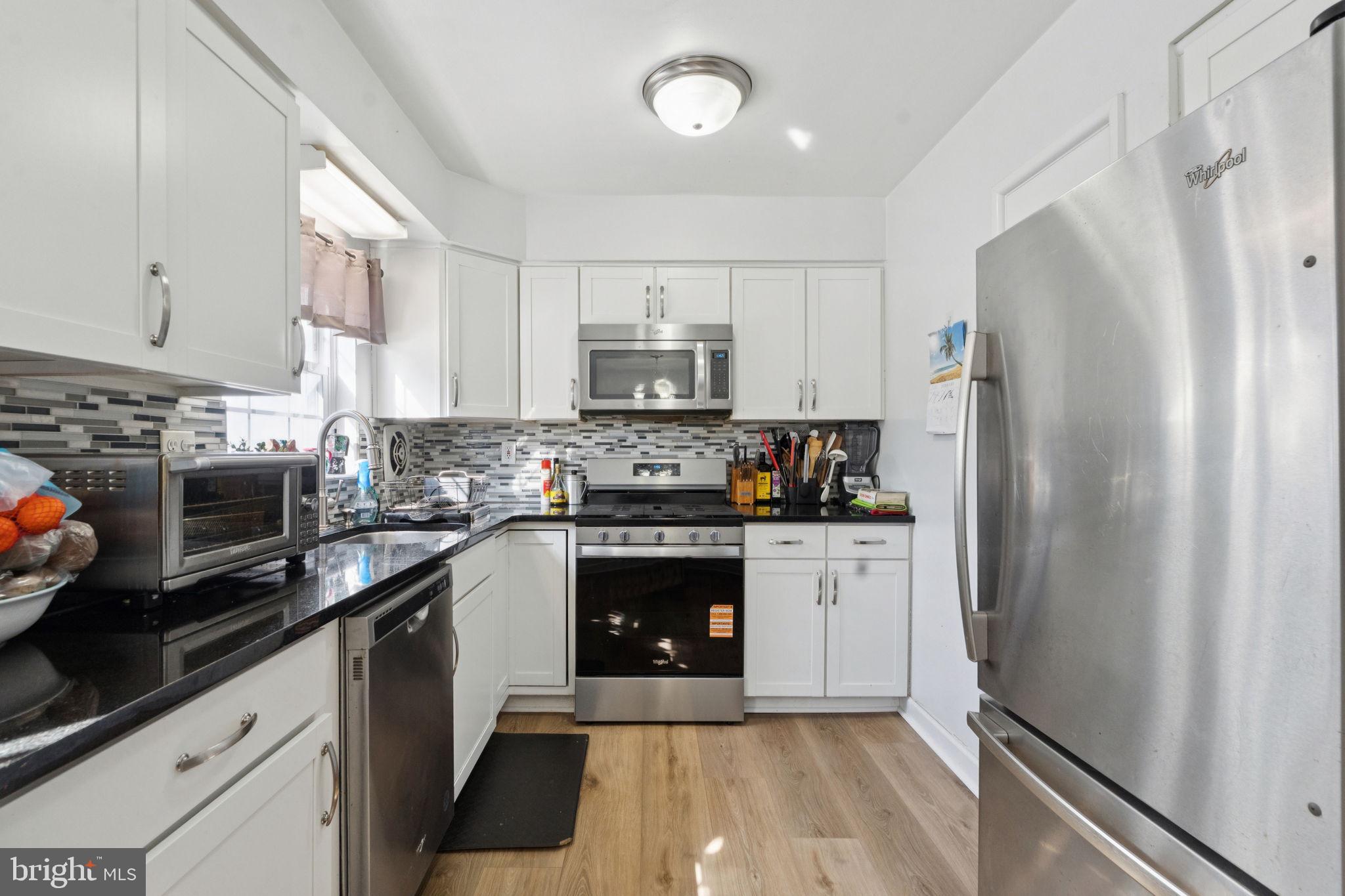 3978 Stevenson Street Philadelphia, PA 19114 - Photo 13 of 25 a kitchen with a refrigerator stove and microwave