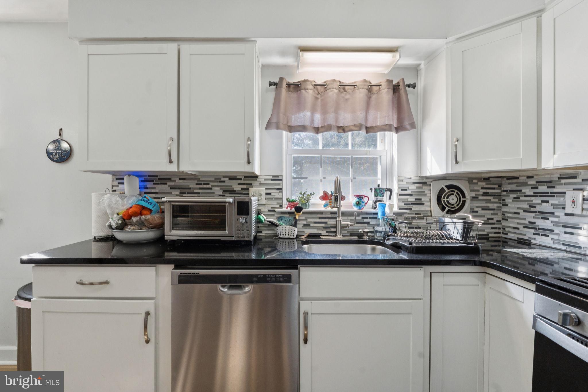 3978 Stevenson Street Philadelphia, PA 19114 - Photo 15 of 25 a kitchen with stainless steel appliances a stove a sink and a white cabinets