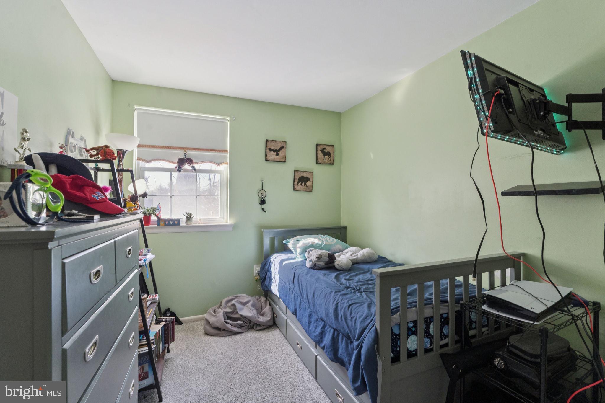 3978 Stevenson Street Philadelphia, PA 19114 - Photo 18 of 25 a bedroom with a bed and wooden floor