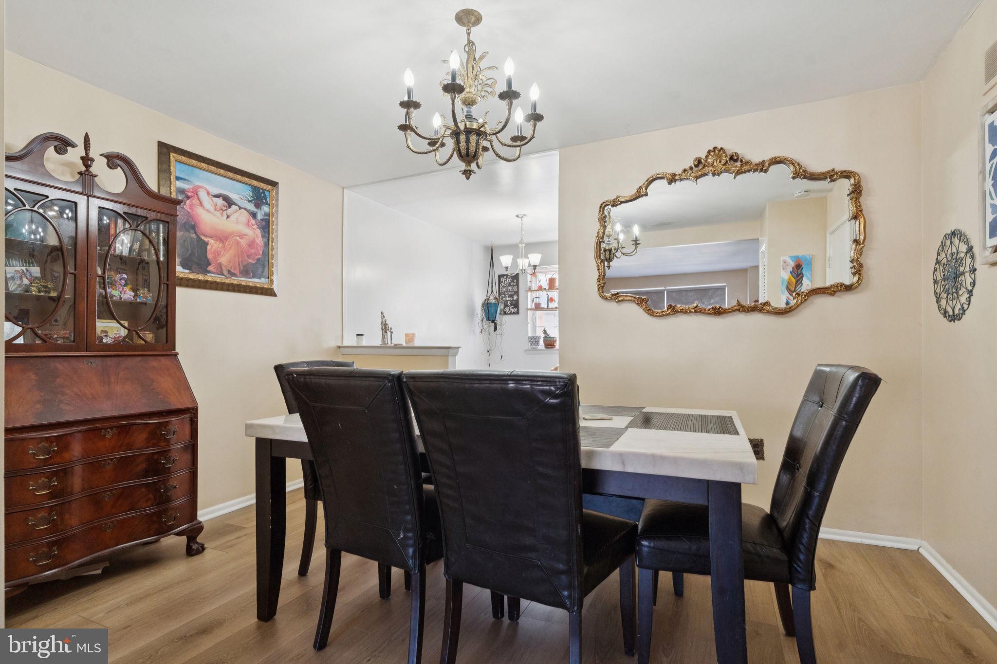 3978 Stevenson Street Philadelphia, PA 19114 - Photo 10 of 25 a view of a dining room with furniture wooden floor and a chandelier
