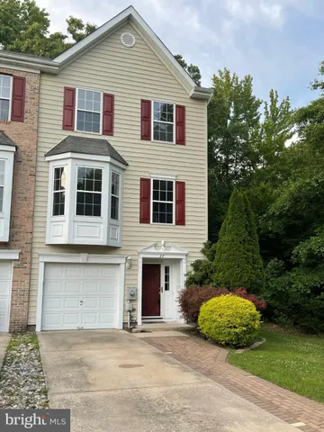 a front view of a house with a garden and garage