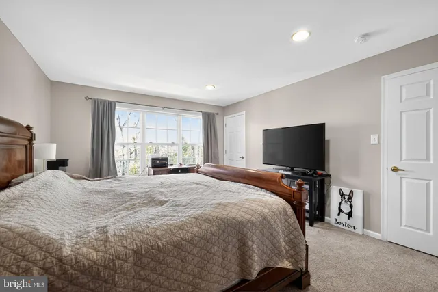 a bedroom with a bed and a television in it